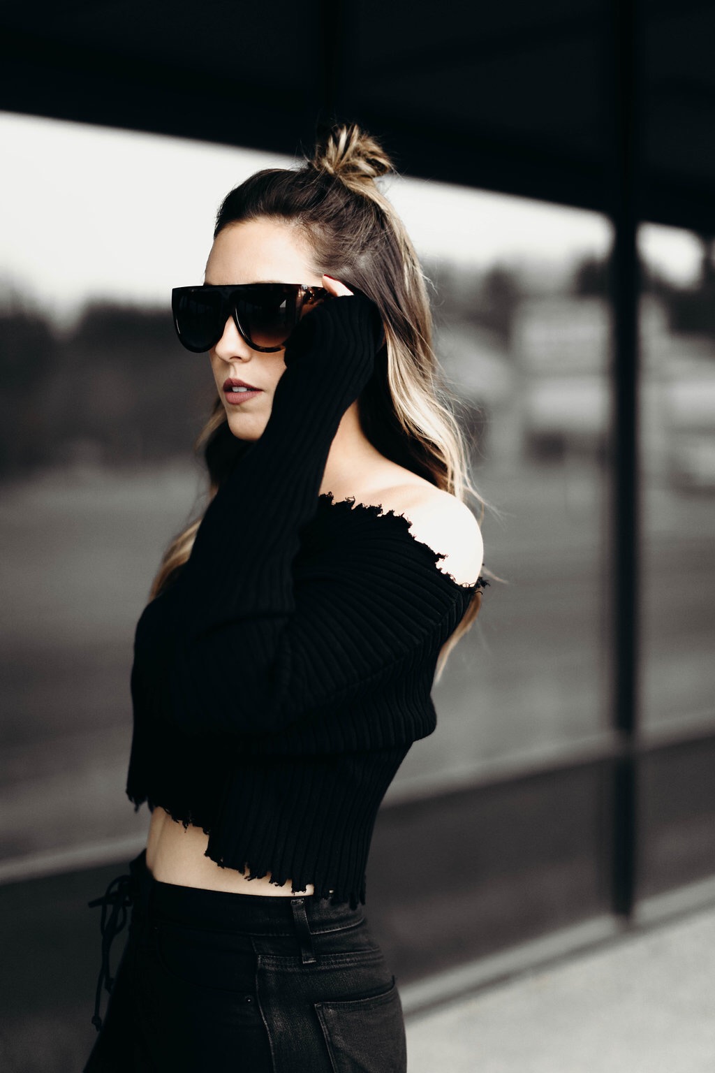 Jenna Boron, creator of life and personal style blog, Balance & Chaos, wears Hudson Bullocks High Rise Flare jeans, AKIRA raw hem sweater, shield sunglasses